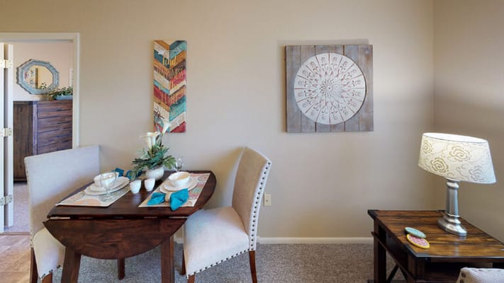 Well-decorated corner of a resident room with dining table