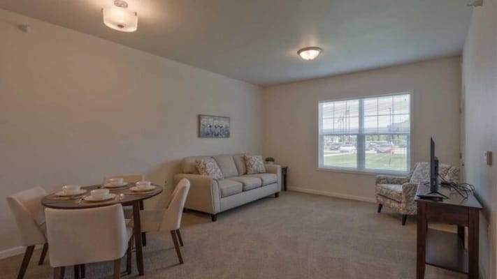 Well-furnished resident room with dining area