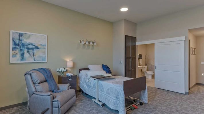 Private resident room with comfortable seating and bathroom