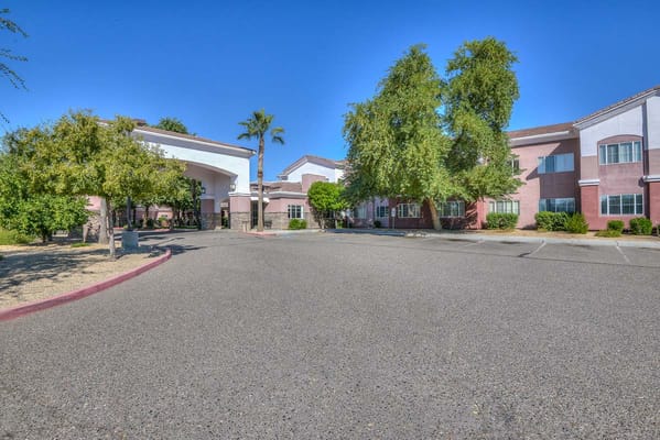 Exterior view of a senior living facility with landscaping