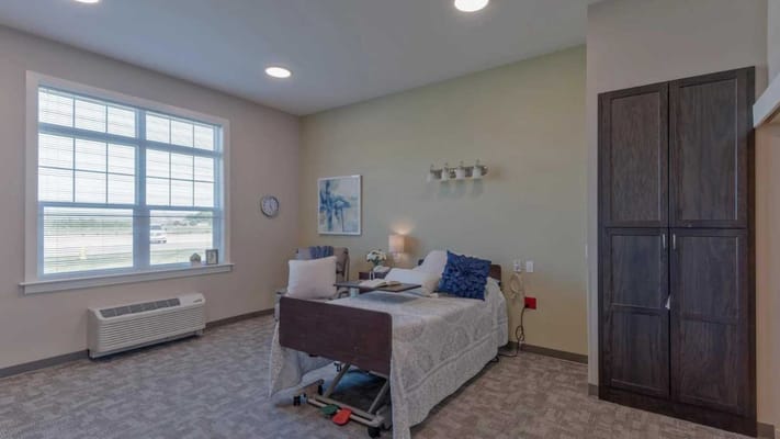 A well-furnished private resident room with a bed and window