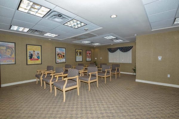 Empty activity room with seating and movie posters