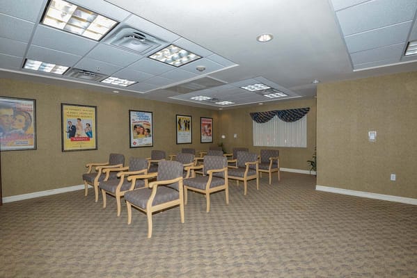 Empty activity room with seating and movie posters