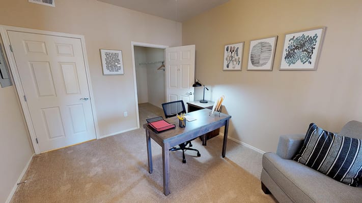 Interior view of a private resident room with desk