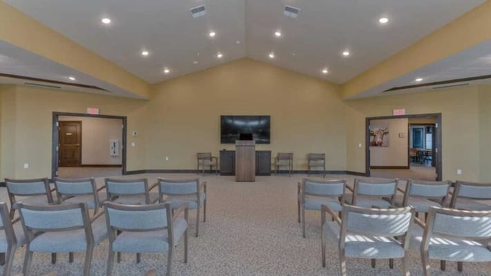 Interior view of a common area with chairs and a podium