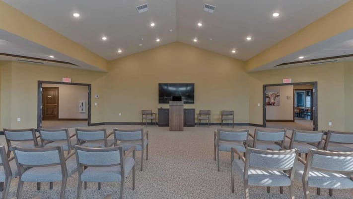 Interior view of a common area with chairs and a podium