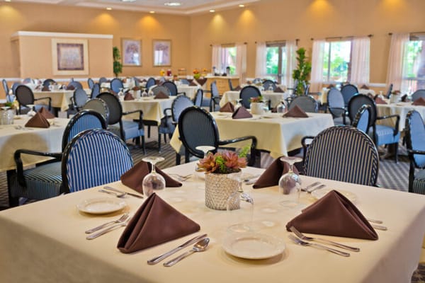 Elegant dining area set for meals with flowers