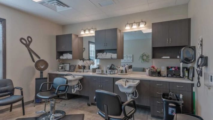 Beauty salon area with styling chairs and mirrors