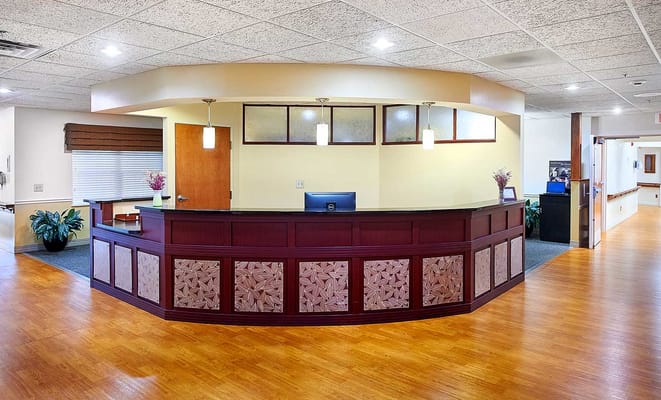Reception area of a senior living facility with wooden desk
