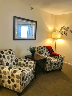Cozy seating area with patterned chairs and lamp