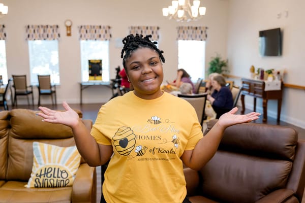 Staff member engaging with residents in a common area