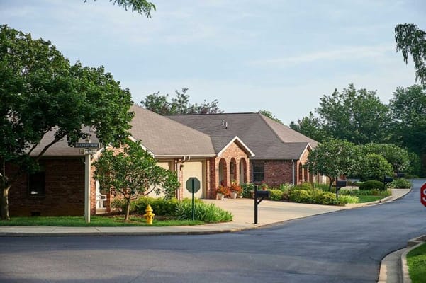 Exterior view of a senior living facility with landscaping