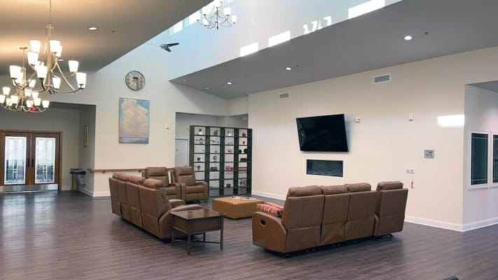 Bright common area with cozy seating and a fireplace