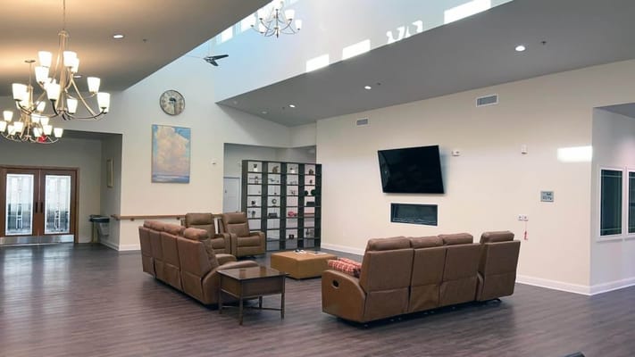 Bright common area with cozy seating and a fireplace