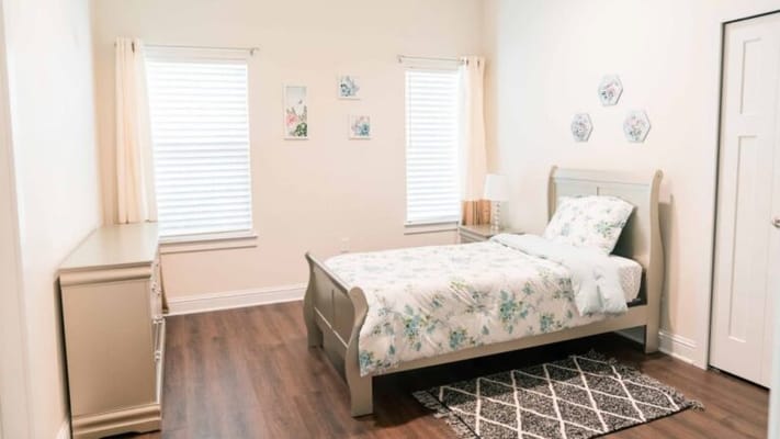 Cozy bedroom with floral bedding and natural light