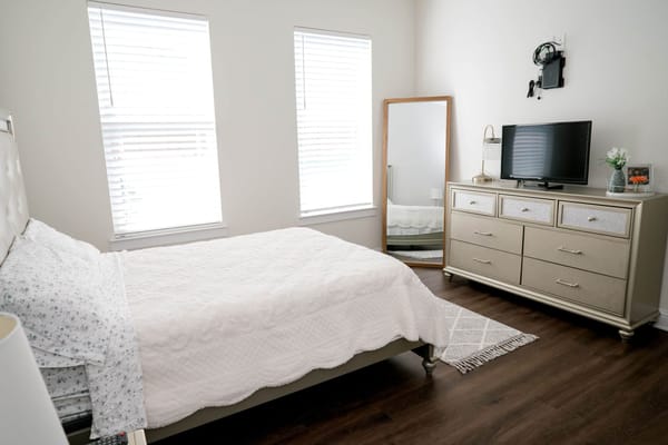 Cozy private resident room with a bed and TV