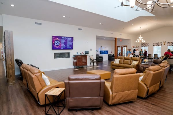 Welcoming common area with seating and screens