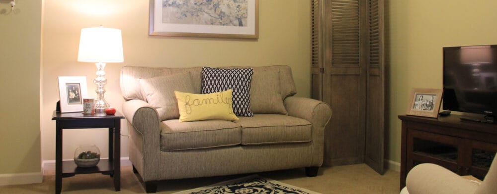 Cozy living room setting with a sofa and lamp