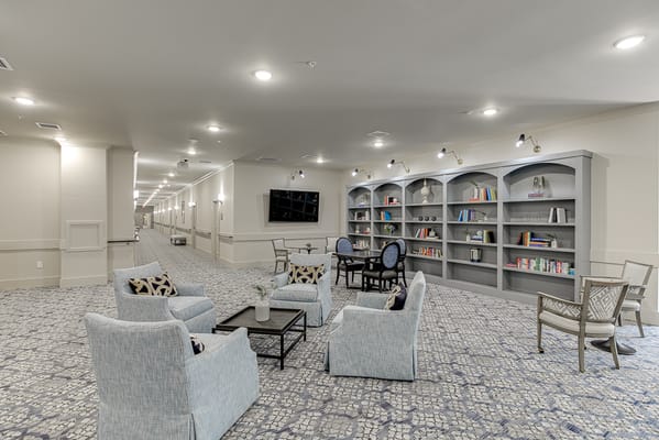 Cozy common area with seating and shelves in the background