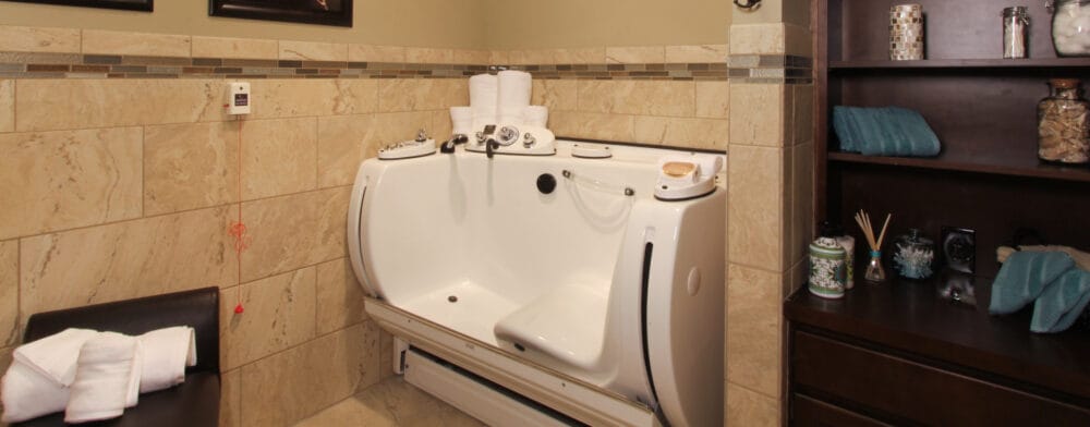 Accessible bathroom with a walk-in bathtub and towels