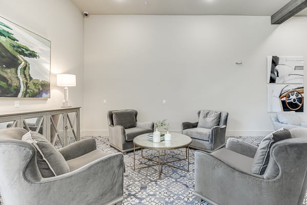 Modern assisted living common area with seating and artwork