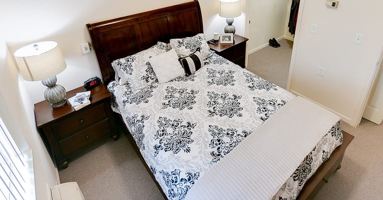 Private resident room with a bed and bedside tables