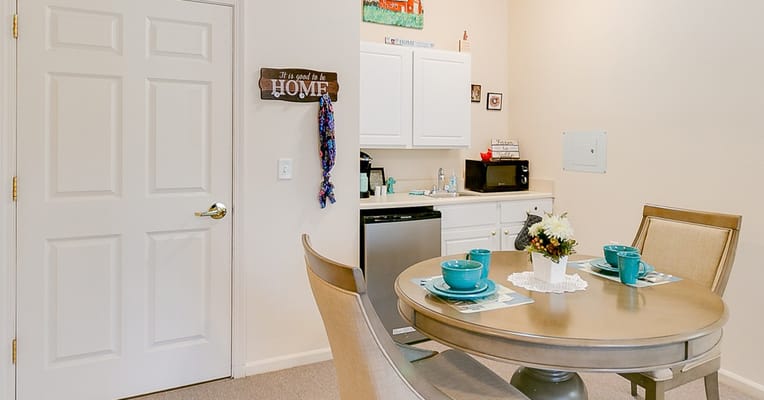 Bright interior of a resident's room with dining area