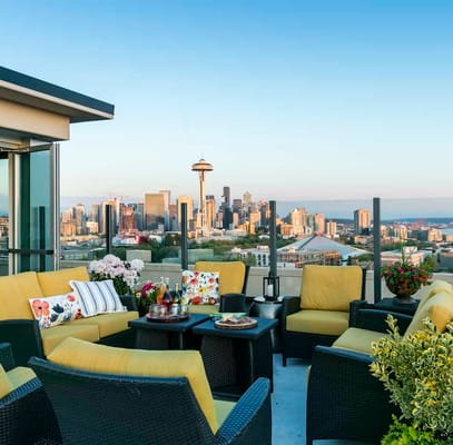 Rooftop outdoor seating area with city skyline view