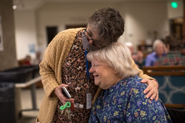 Staff member embracing a resident in a common area