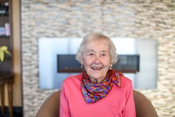Senior woman smiling in a cozy lounge area