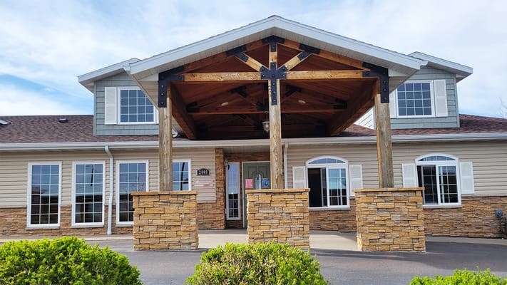 Entrance of BeeHive Homes facility with wooden canopy
