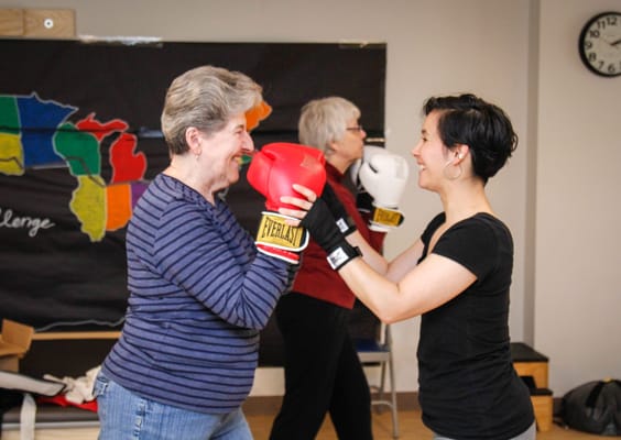 Residents participating in a boxing exercise class