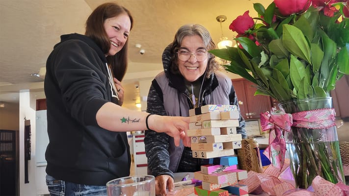 Residents enjoying a game together with flowers in the foreground