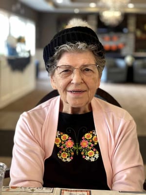Resident smiling while seated in a common area