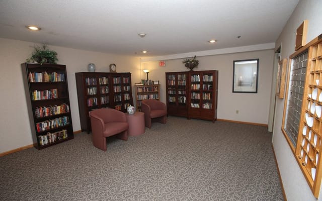 Interior view of a cozy library area with bookshelves