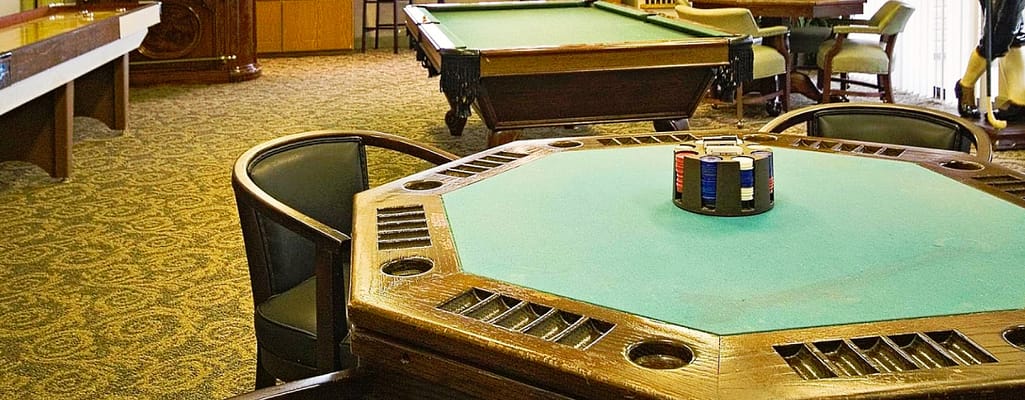 Common area with a card table and pool tables