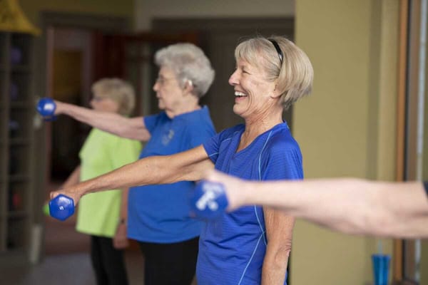 Residents participating in a group exercise class with weights