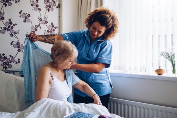 Caregiver assisting a resident in a room