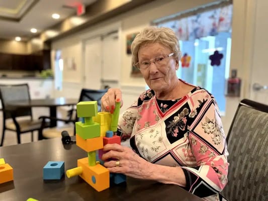 Resident engaging in a colorful building block activity