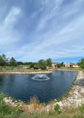 Beautiful outdoor pond with fountain in the community