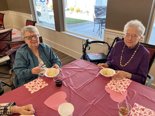 Two residents enjoying ice cream in a common area