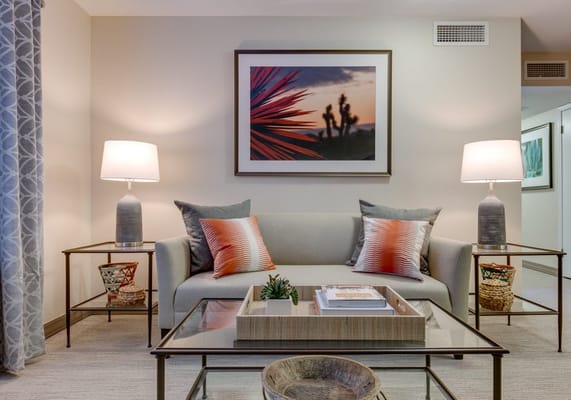 A cozy common area with a sofa and lamps