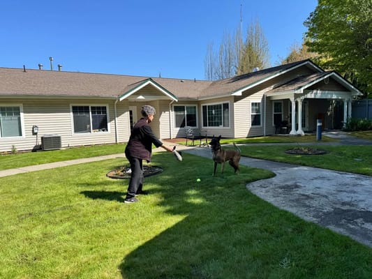 Resident playing with a dog in the garden