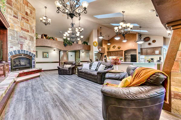 Interior view of a common area with leather sofas and a fireplace