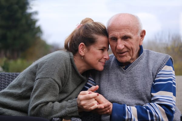 A woman and a senior man enjoying time together outdoors