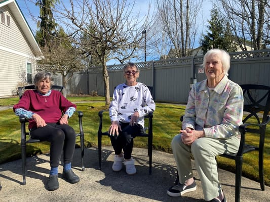 Residents enjoying the outdoor space in chairs