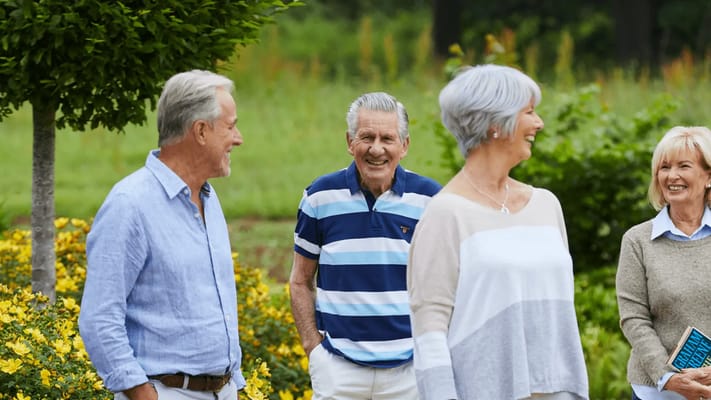 Seniors enjoying a walk in a garden area