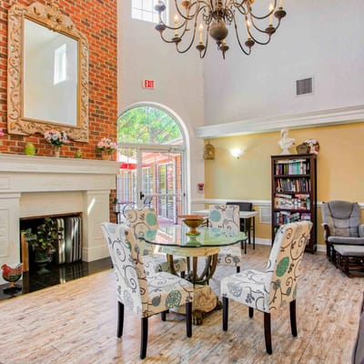 Bright common area with chairs and fireplace
