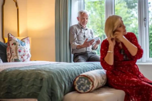 Residents engaged in conversation in a cozy room