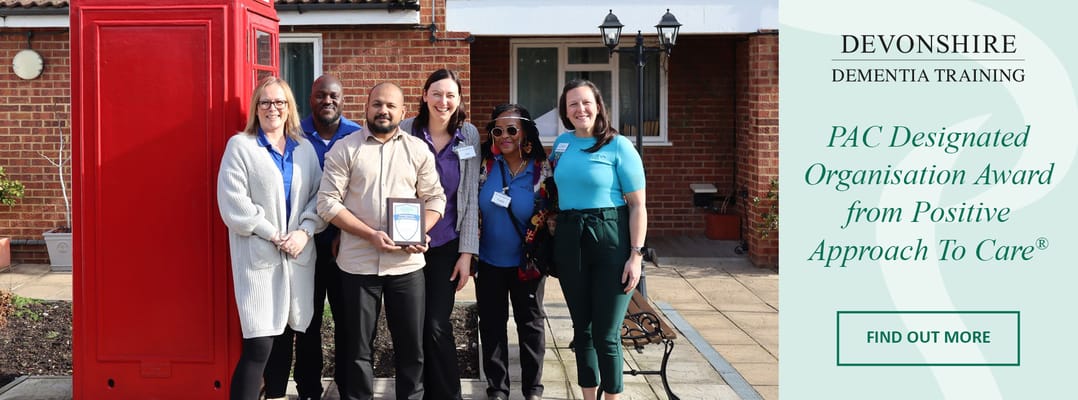 Staff and residents celebrating an award in the garden